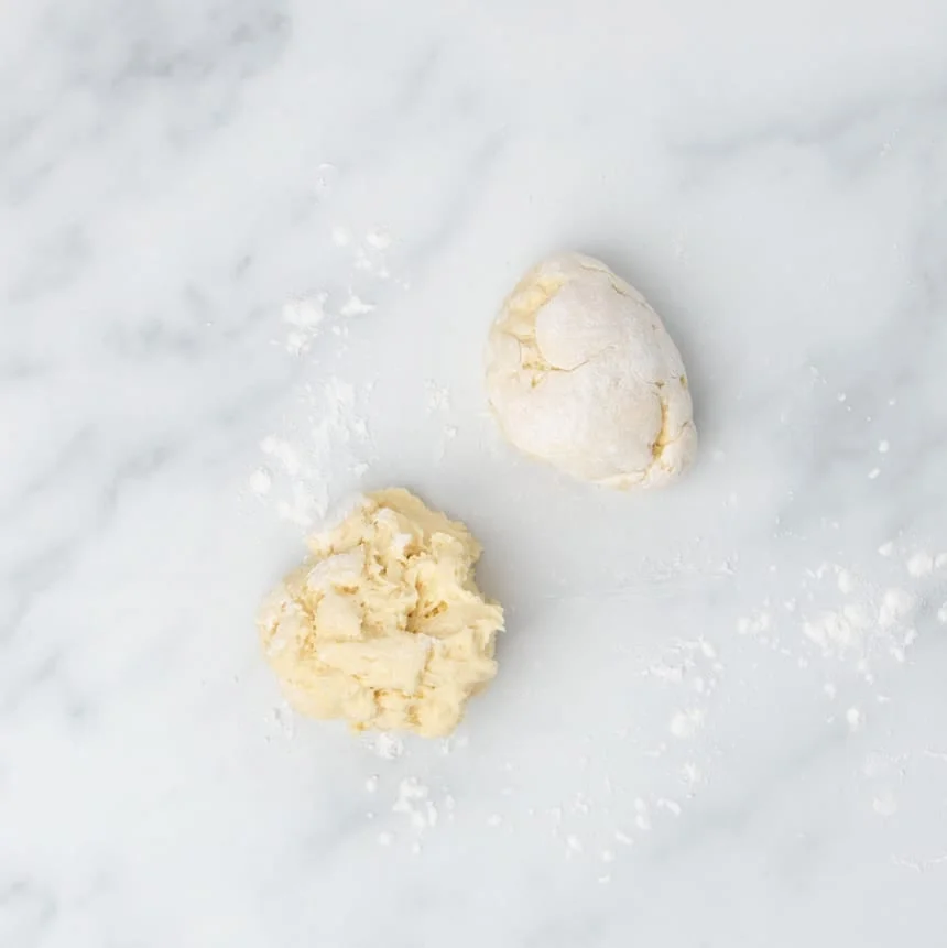 2 small pieces of raw wet dough, one covered in white flour, one not