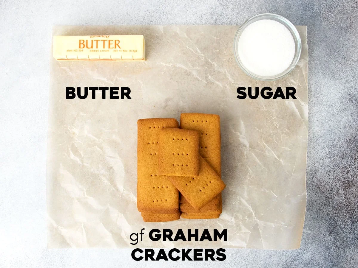 3 ingredients for gluten free graham cracker crust on wax paper with names of each ingredient in black block lettering below it.