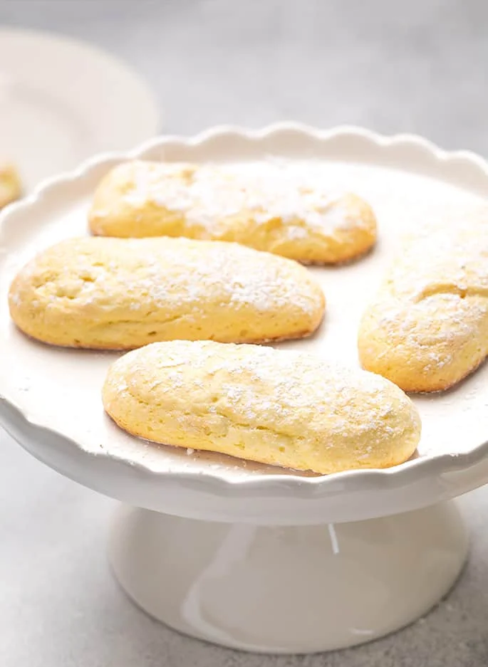 4 whole ladyfingers on small round white cake stand
