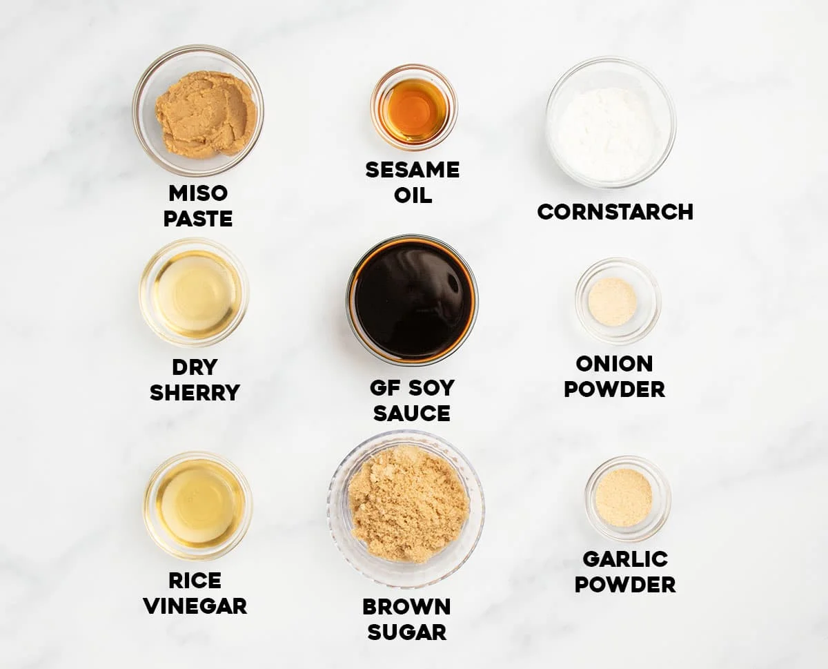 9 gluten free stir fry sauce ingredients in small glass bowls with ingredient names written below each ingredient