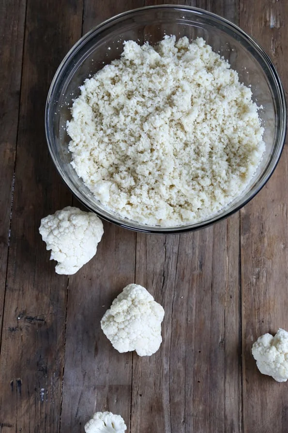 A bowl of cauliflower on wooden surface
