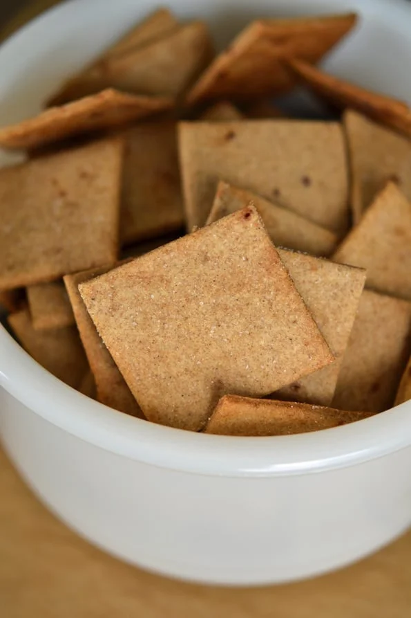 A bowl with baked gluten free wheat thins style crackers 