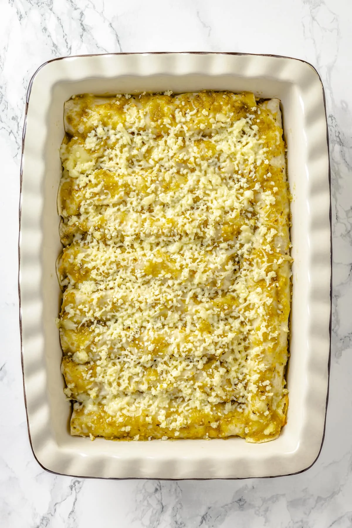 A casserole dish of chicken green enchiladas