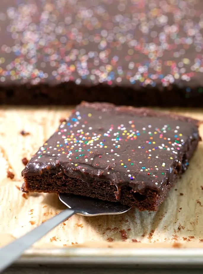 A close up of a chocolate cake with a slice cut out