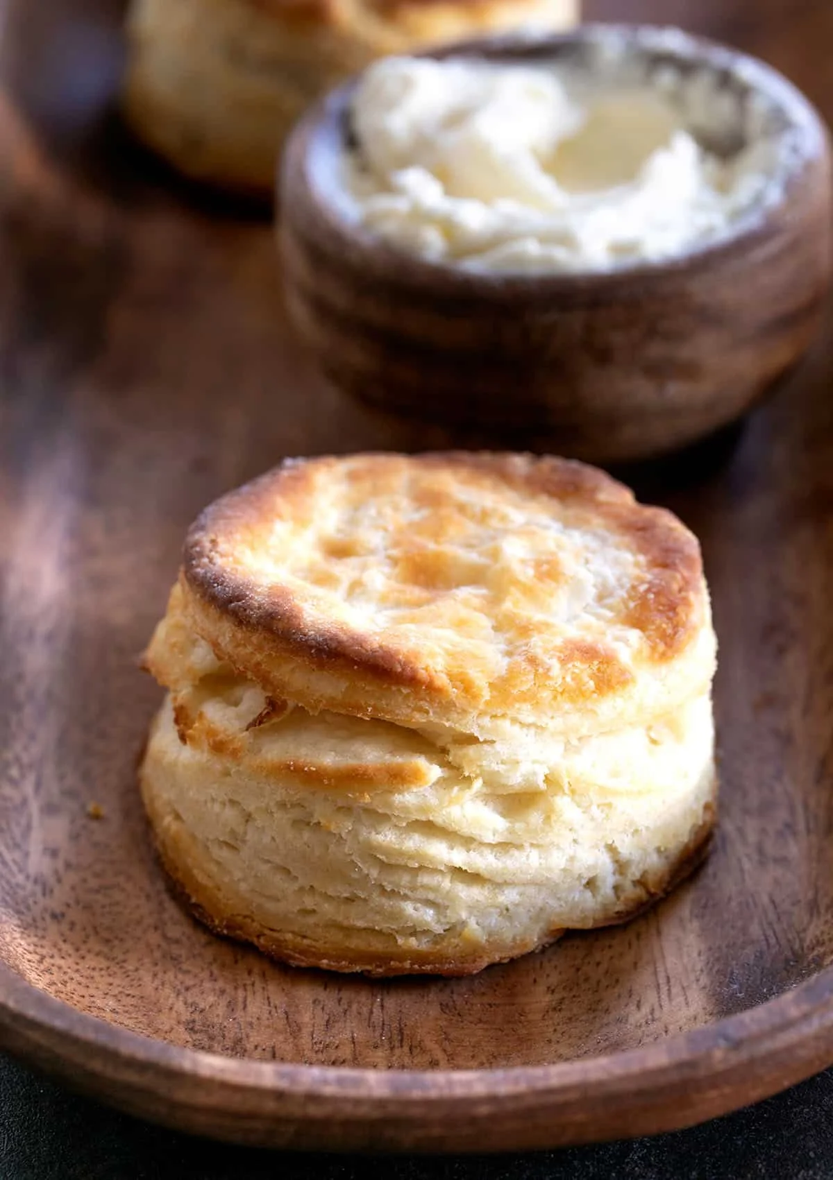A close up of a layered biscuit with a brown top.