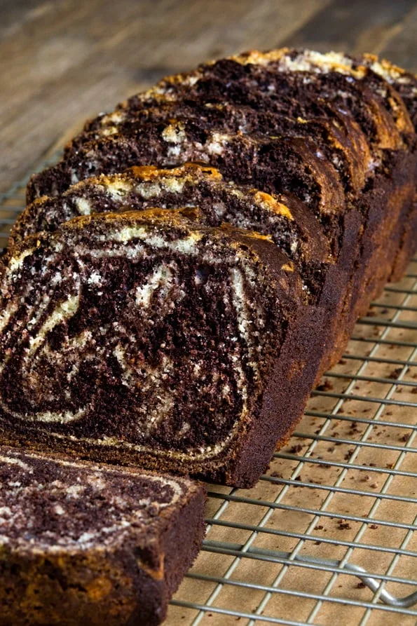 A close up of a piece of marble loaf cake
