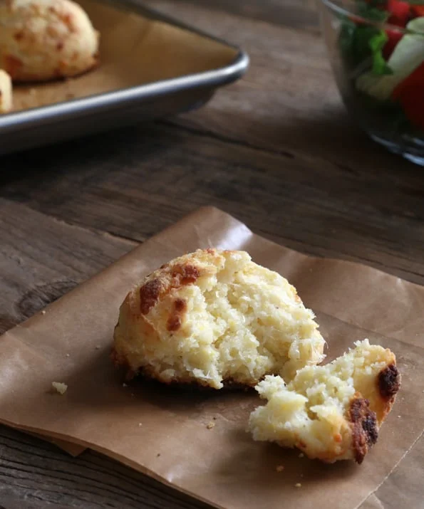 A close up of the inside of a biscuit on brown surface 