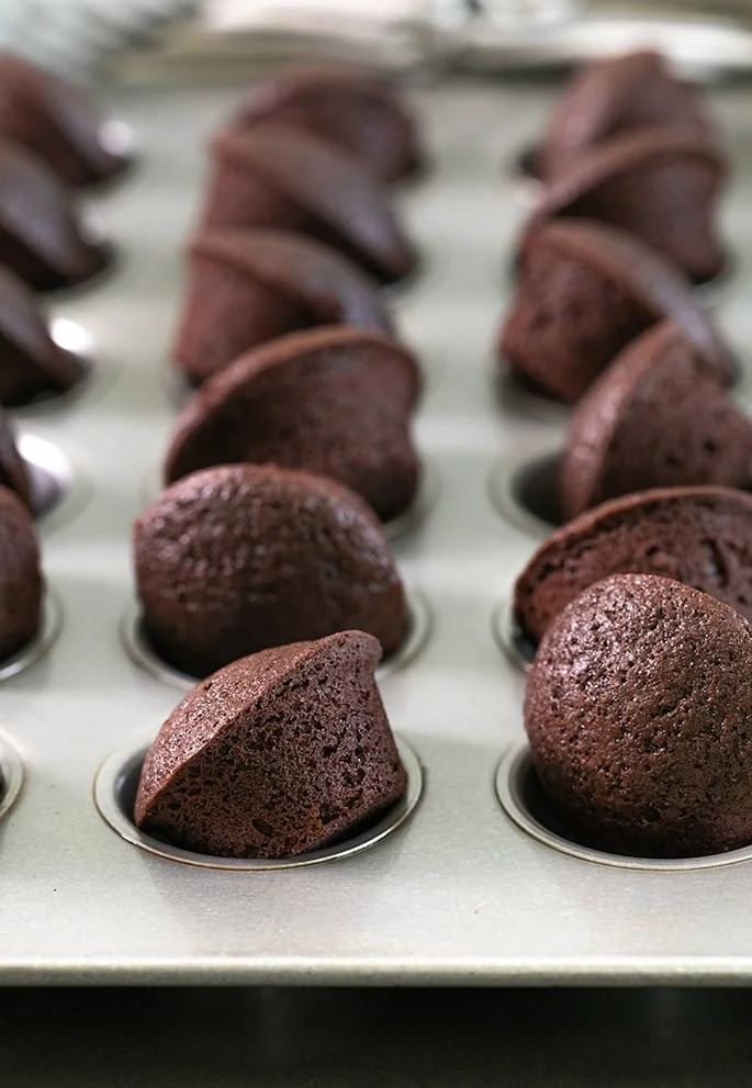 A close up two bite brownies baked in a muffin tin