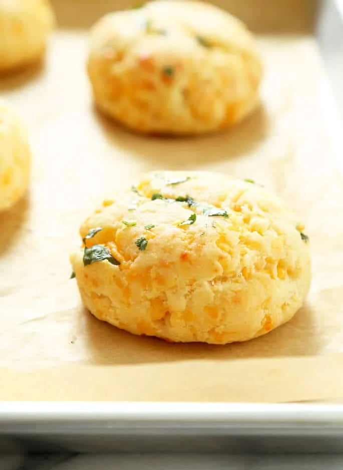 A closeup of one gluten free cheddar bay biscuit on a tray