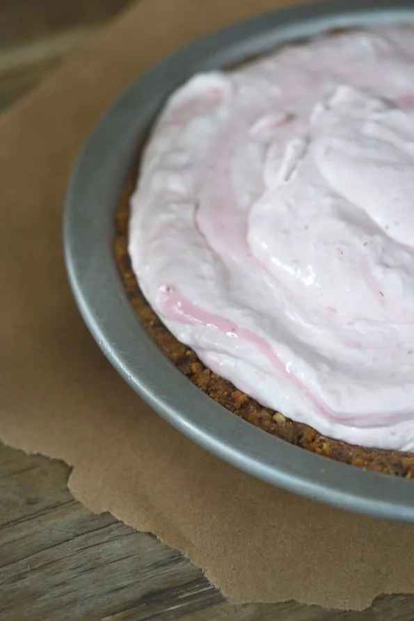 A cool and refreshing no bake gluten free pie, made with whipped cream, plain yogurt and reduced fresh strawberries. Get this no bake recipe!