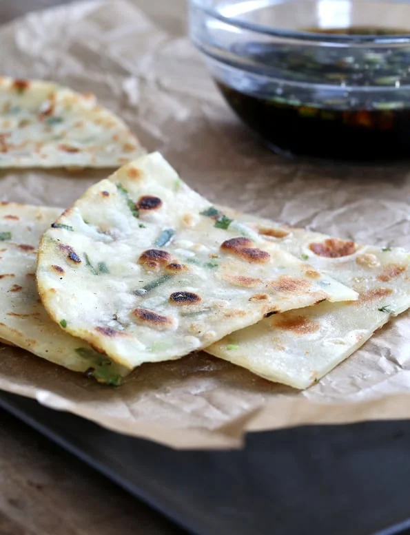 A few scallion pancakes on brown surface 