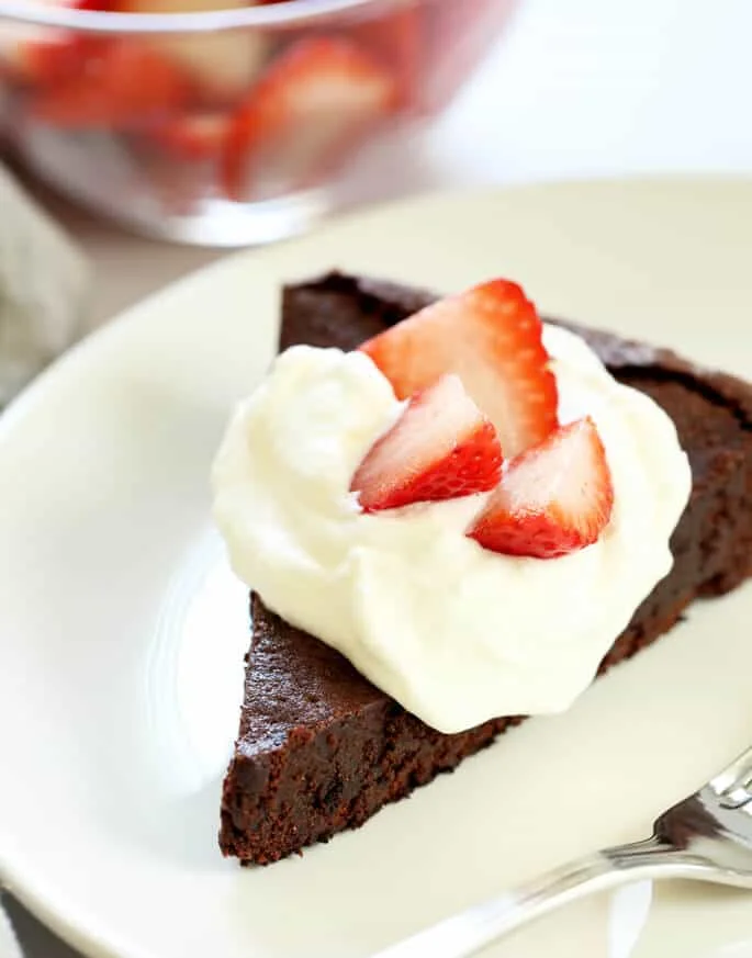 A flourless chocolate cake is one of those restaurant-style desserts that it's tempting to think is too fussy to make at home. It's naturally gluten free, and you can whip one up at home any time!