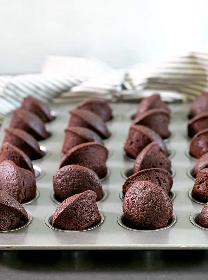 A miniature muffin tin with two bite brownies