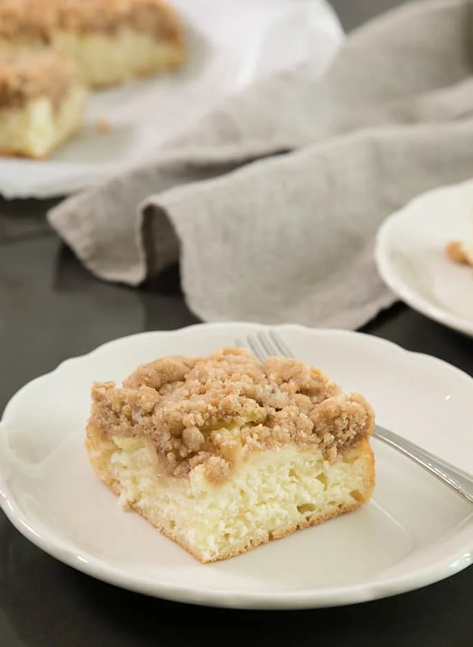 A piece of the cake and a fork served on a white plate. 