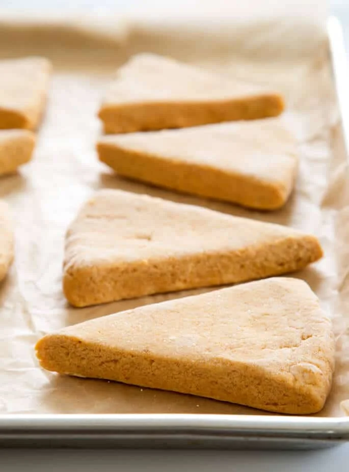A side view of pumpkin scones on brown paper