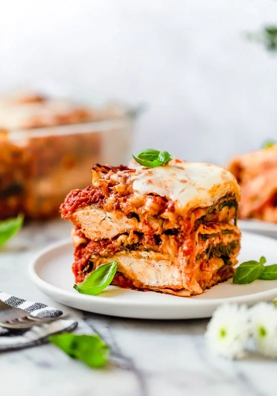 A slice of chicken parmesan lasagna on a plate