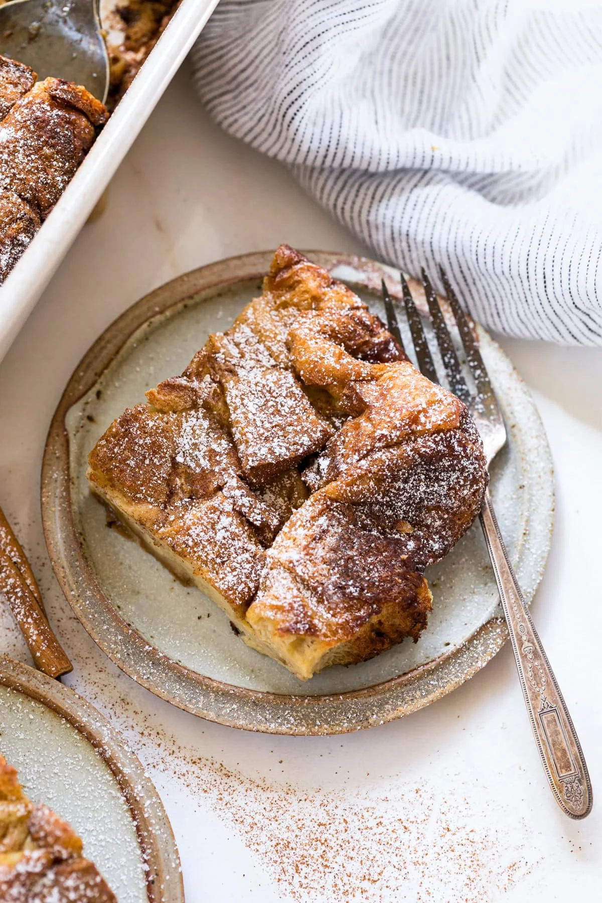 A slice of overnight creme brulee French toast on a plate with a fork.