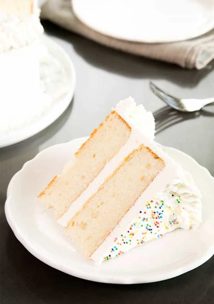 A slice of vanilla layer cake on a plate
