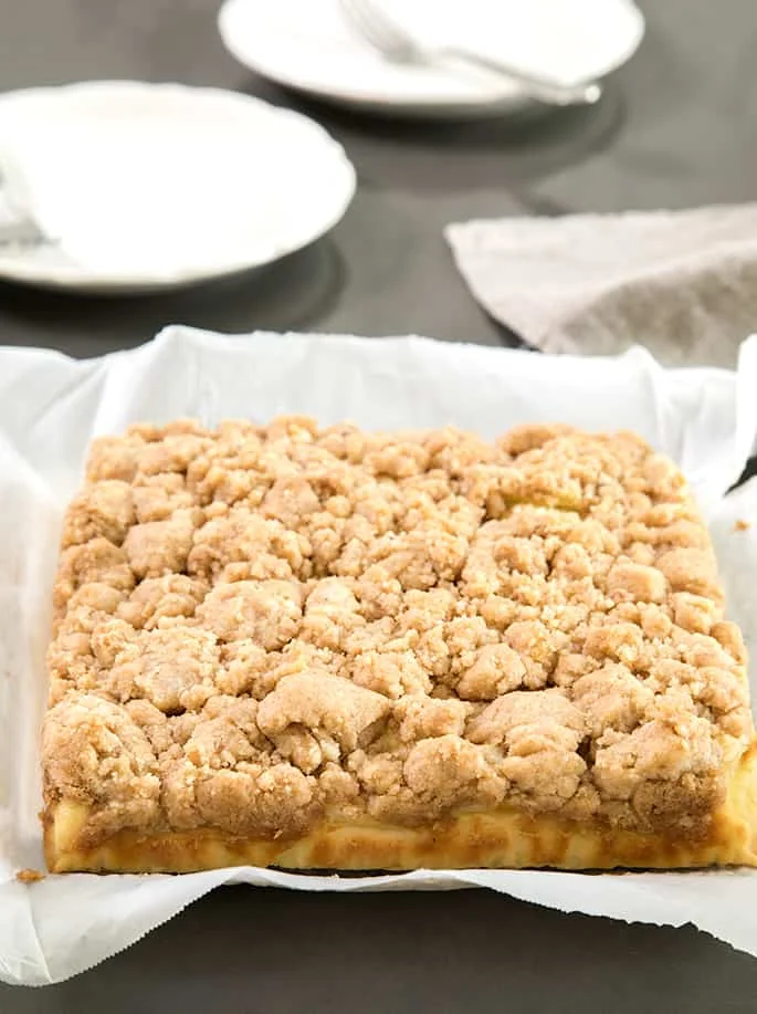 A square of the cake served on baking paper. 