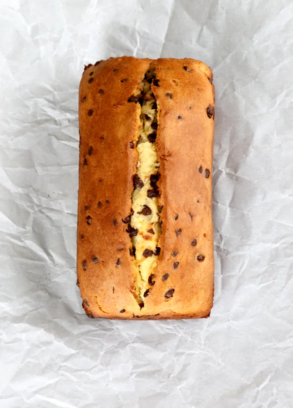 A whole loaf of chocolate chip yogurt bread on white paper