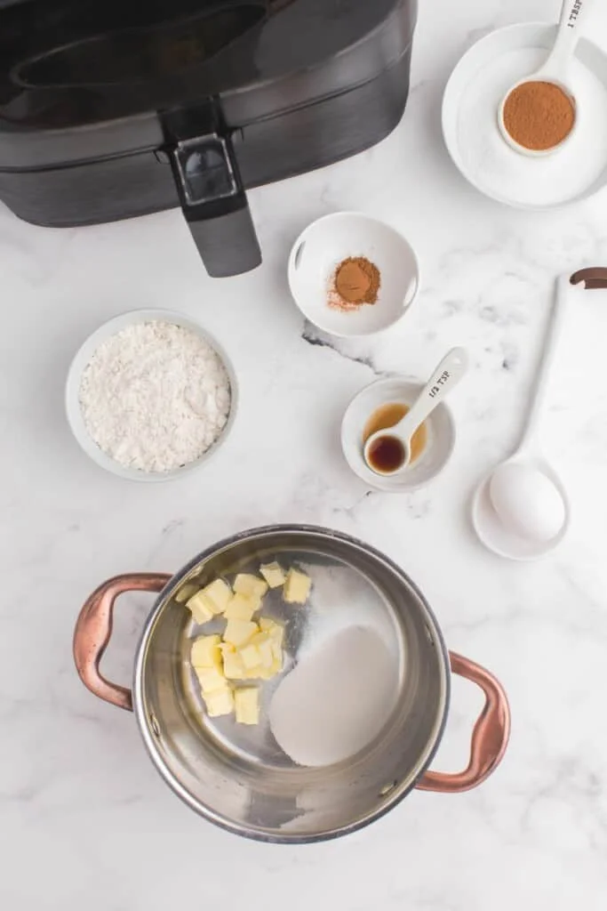 adding butter and sugar to pot 