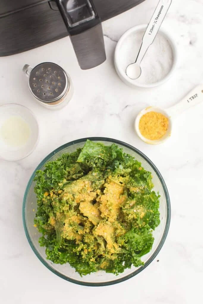 adding seasoning to air fryer kale chips