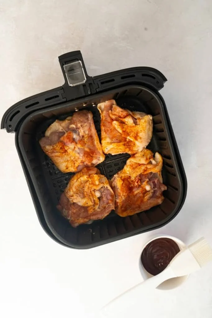 air fryer basket with chicken thighs