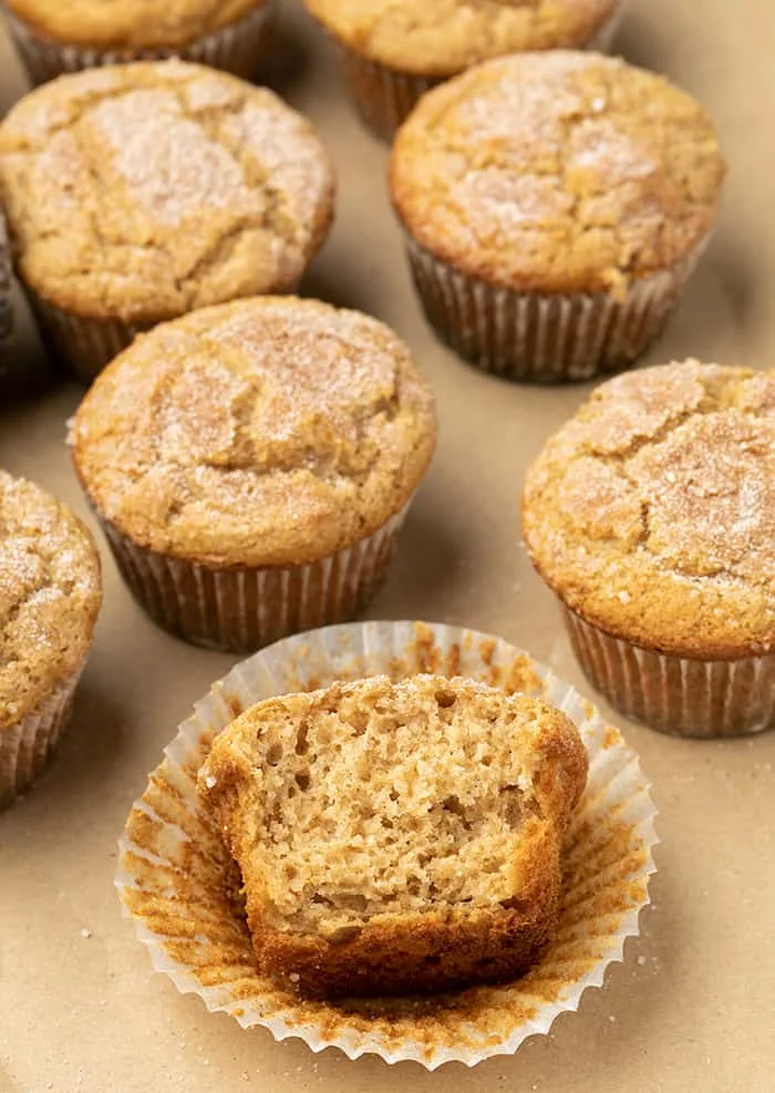 Applesauce muffin broken in half sitting in liner
