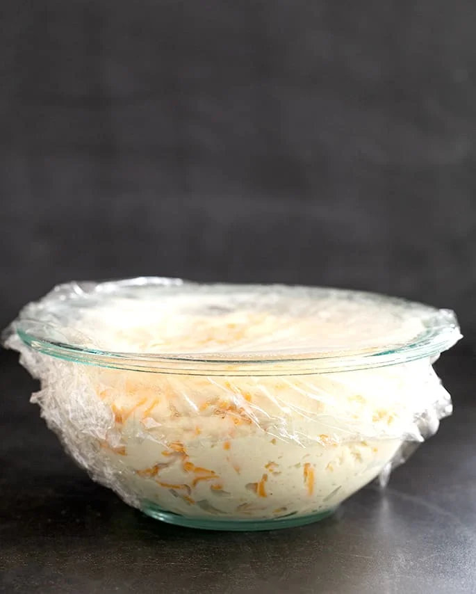 Artisan cheese bread dough raw and unrisen in a bowl