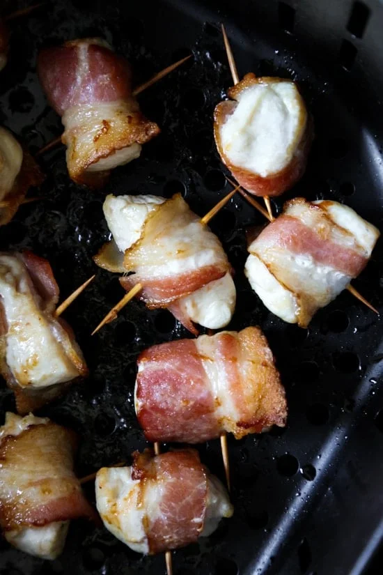 Bacon wrapped chicken bites are the easiest appetizer, made with just TWO ingredients. Using the air fryer, the bacon comes out crisp on the outside, and the chicken juicy and tender inside.