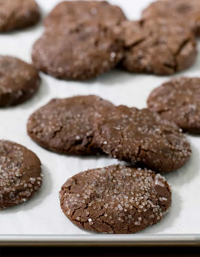 Baked chewy chocolate ginger cookies on a white table