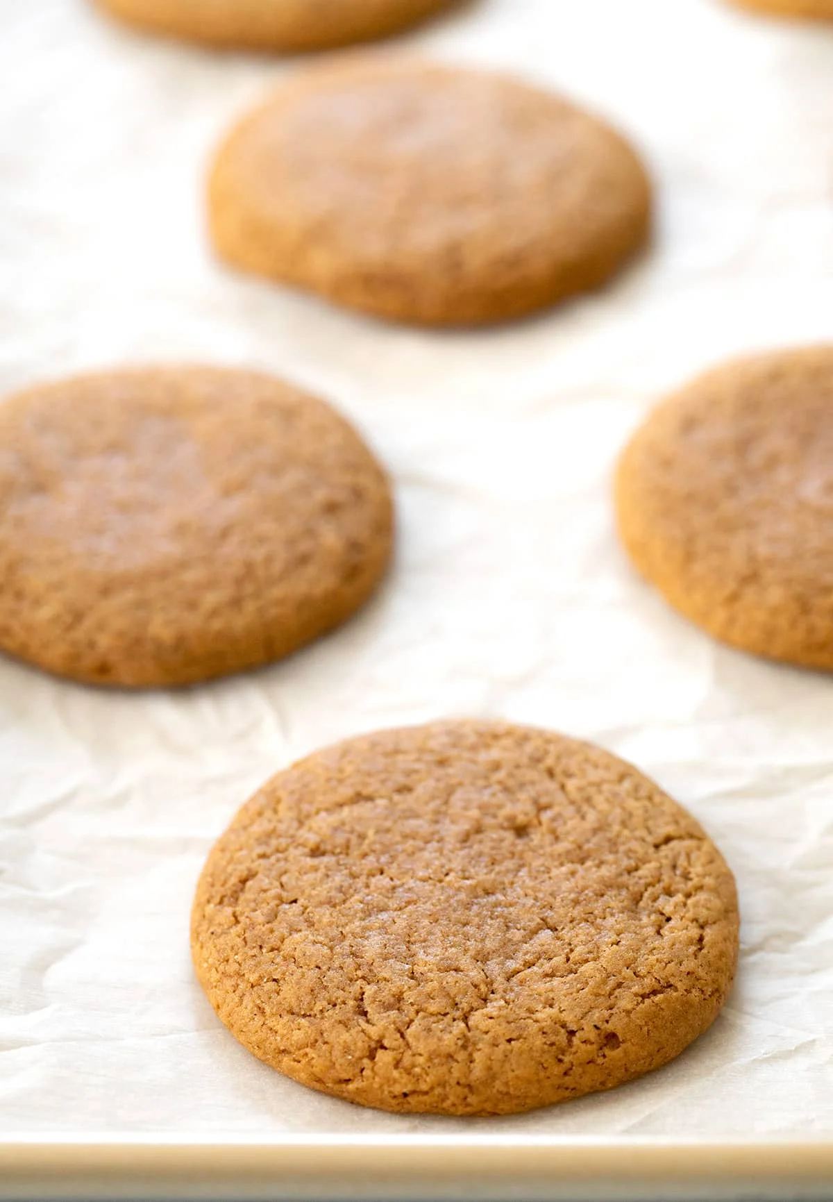 Baked molasses cookies on white paper on tray