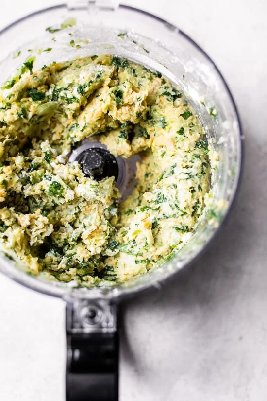 Blended chickpea falafel mixture in a food processor.