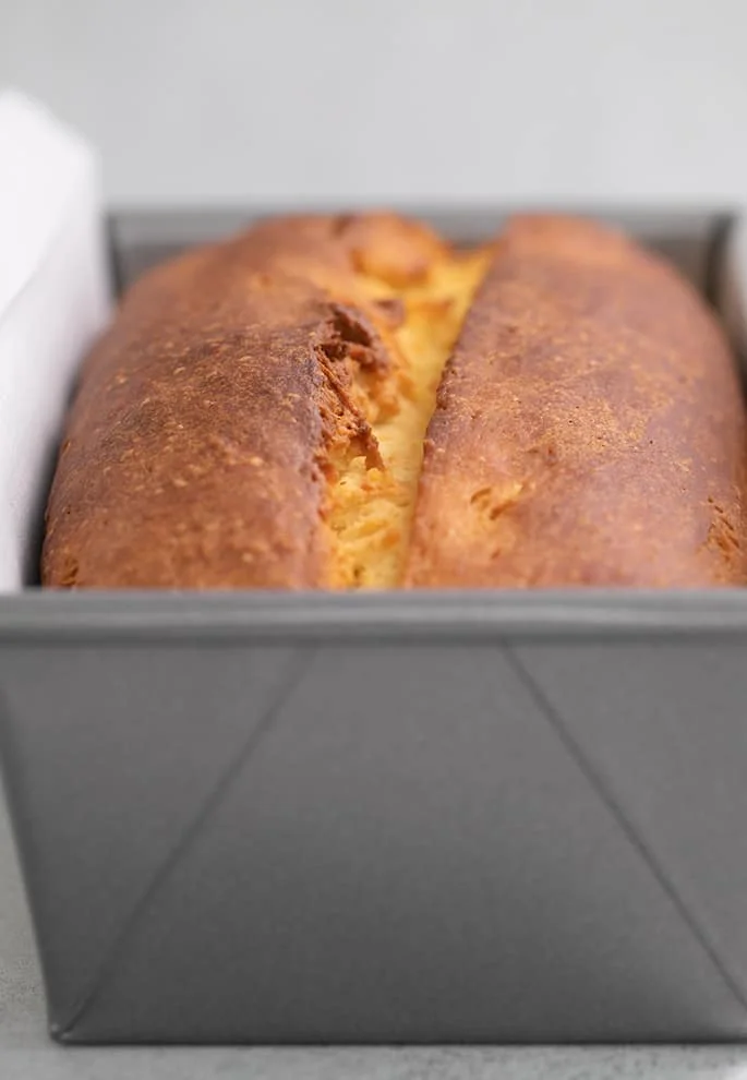 Brioche bread baked in loaf pan with white paper