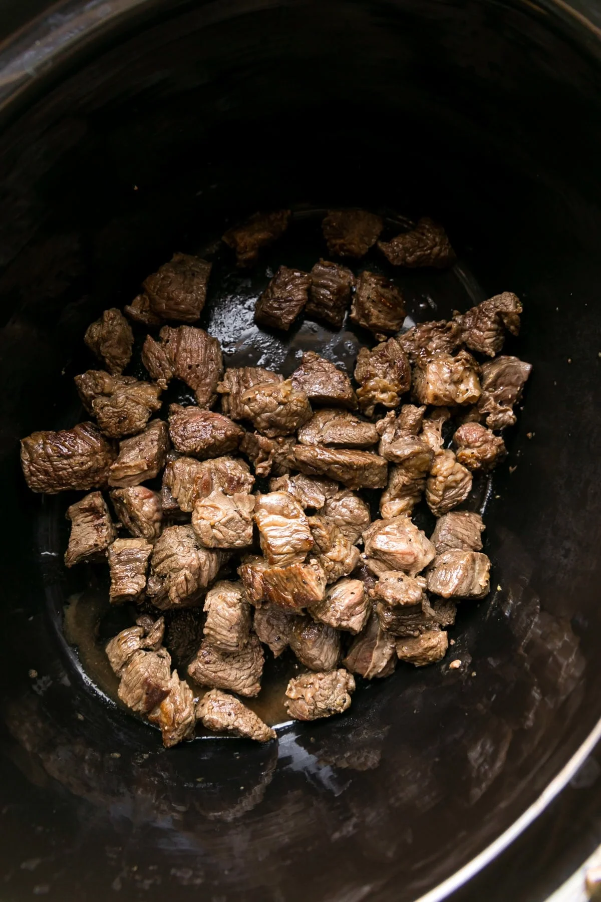 Brown the beef and add to slow cooker.