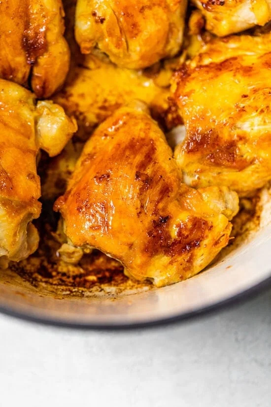 Browned chicken for arroz con pollo in a Dutch oven.