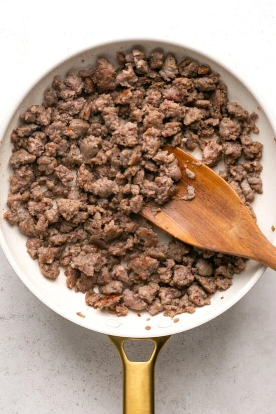 Browned sausage in a skillet.