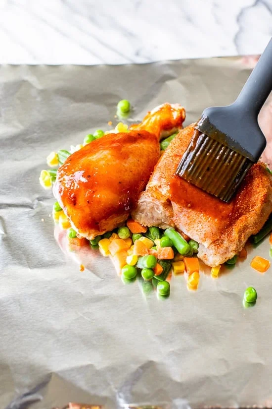 brushing bbq sauce on chicken