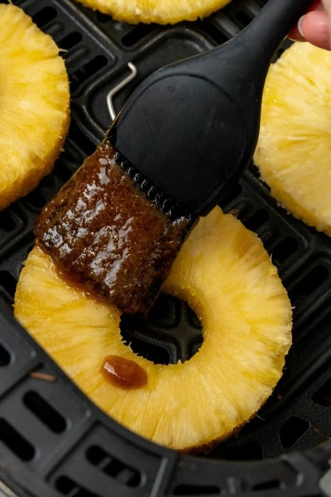 brushing on cinnamon glaze with pastry brush 