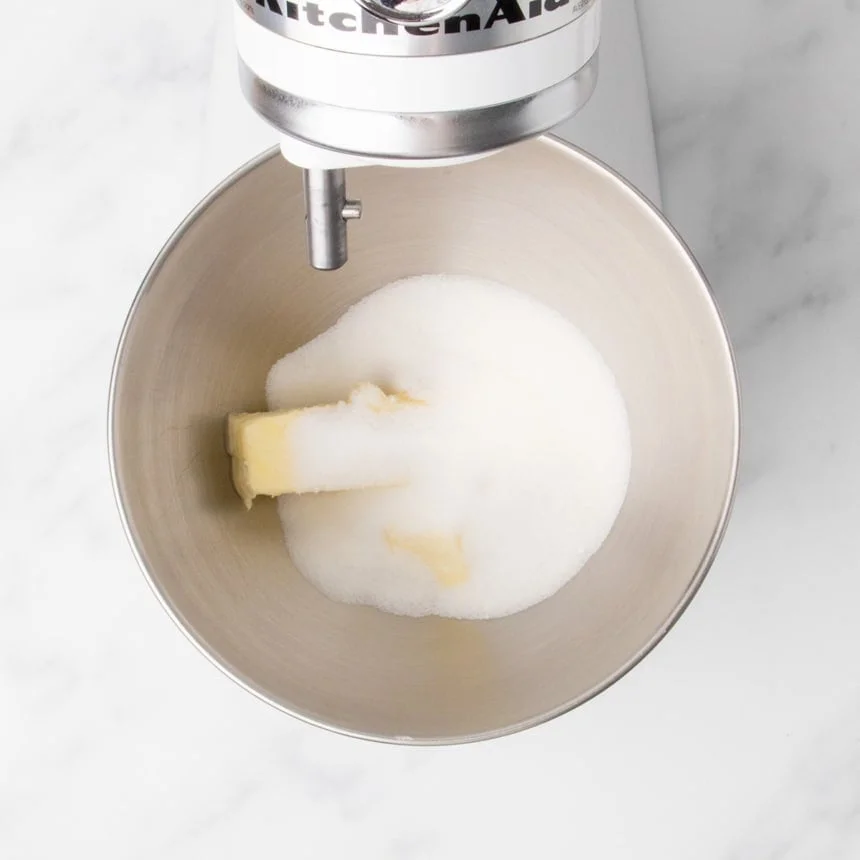 Butter and granulated sugar in a mixing bowl fitted to a stand mixer.