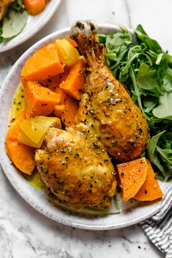 Caramelized sweet potatoes and shallots are the bed for roasted chicken thighs and legs that come together in this one-pot healthy chicken dinner.
