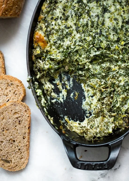 Cheesy hot spinach dip in baking dish
