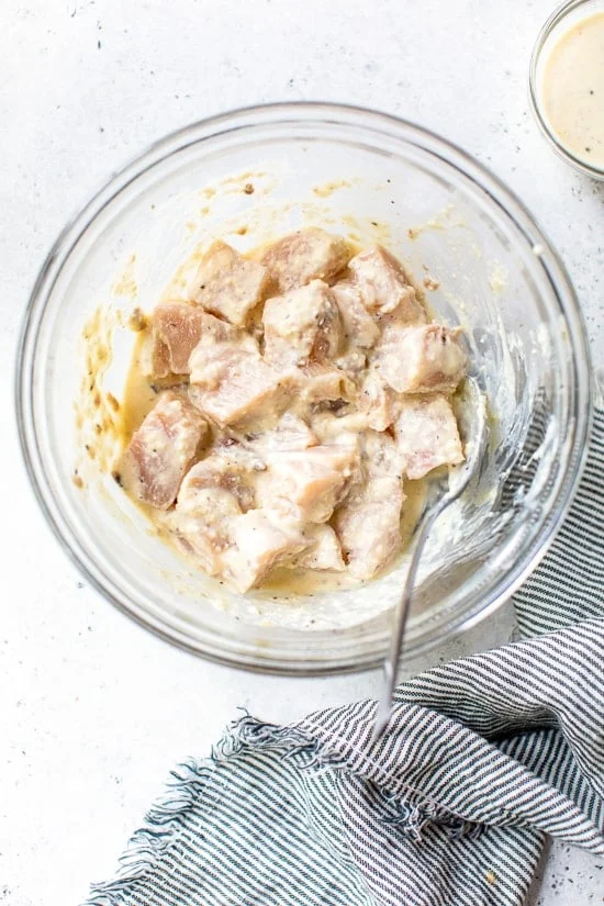 chicken breast marinating in Caesar dressing