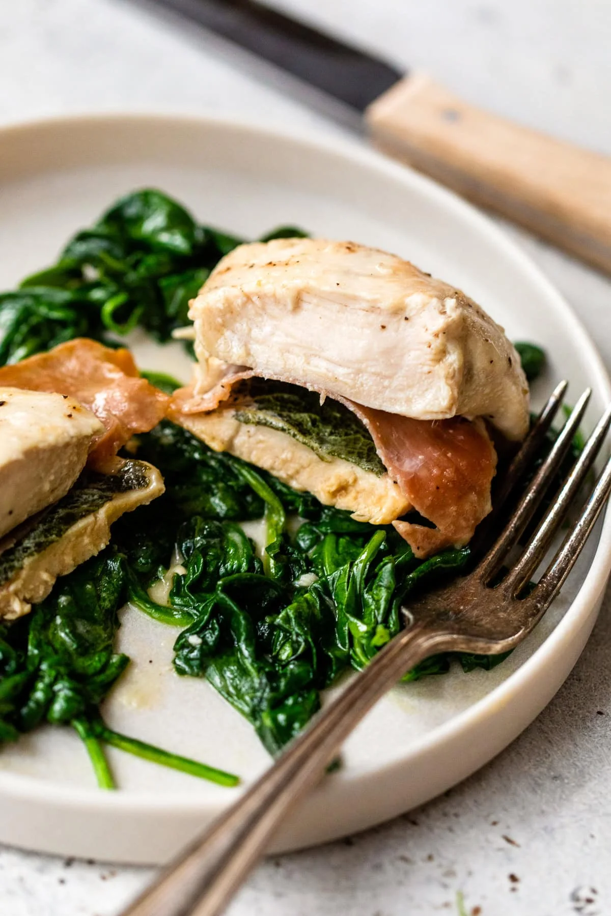 Chicken Saltimbocca with spinach on plate