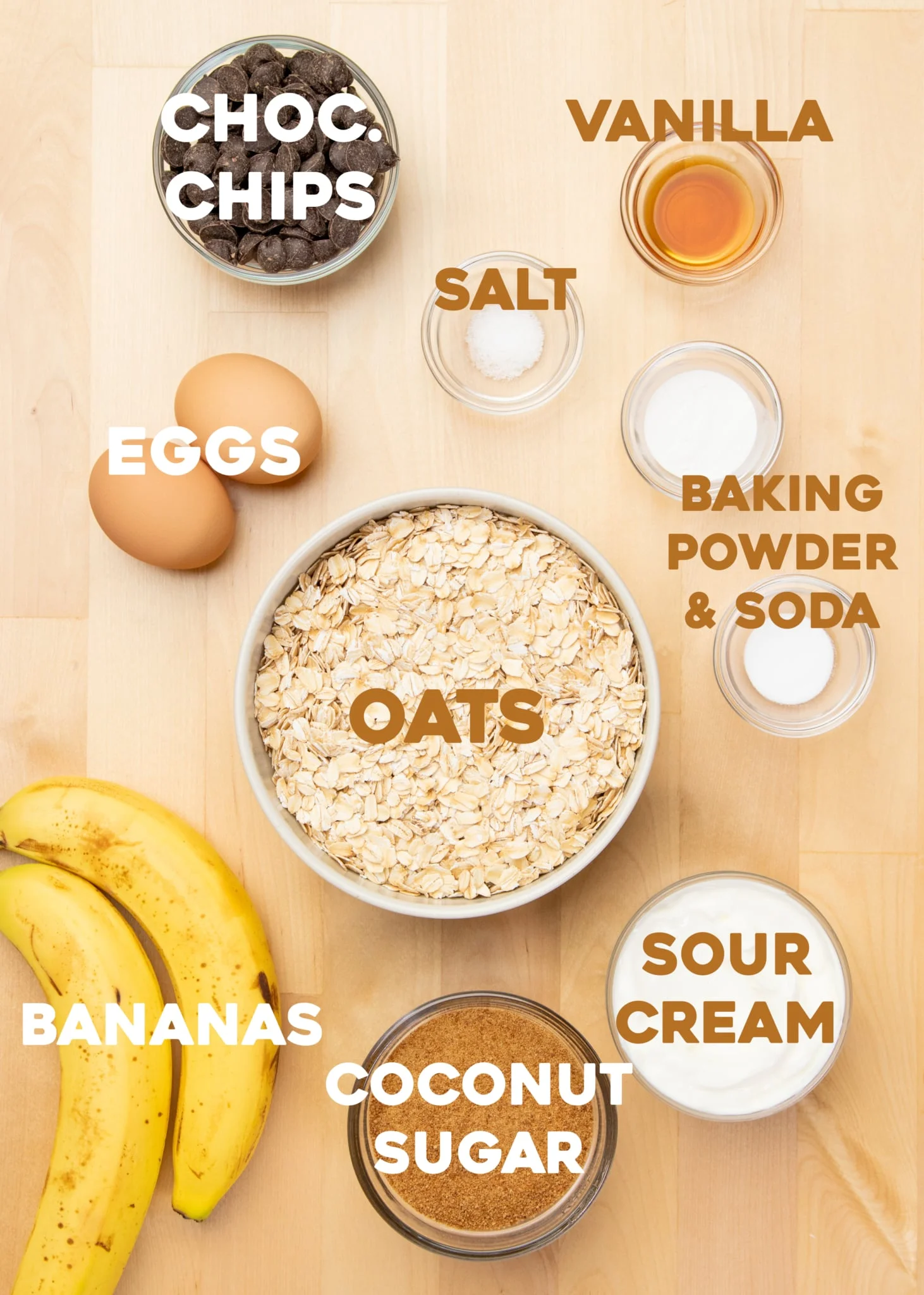 chocolate chips, salt, vanilla, eggs, baking powder, baking soda, oats, sour cream, coconut sugar and 2 bananas