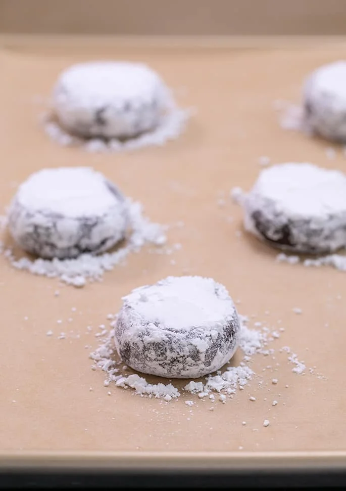 Chocolate crinkle cookie dough shaped with confectioners' sugar