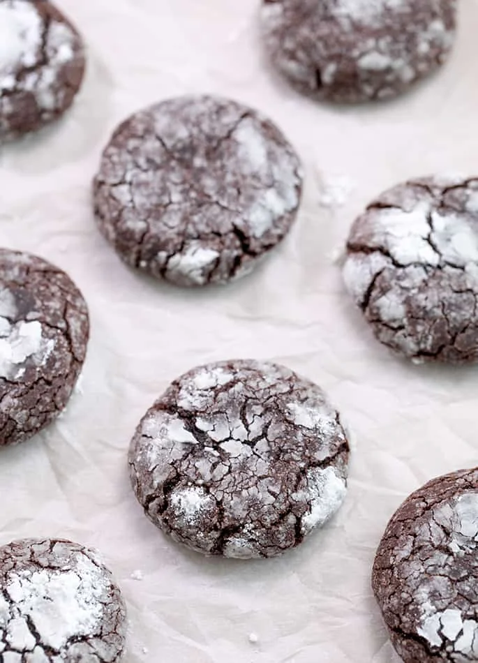 Chocolate crinkle cookies baked on white paper