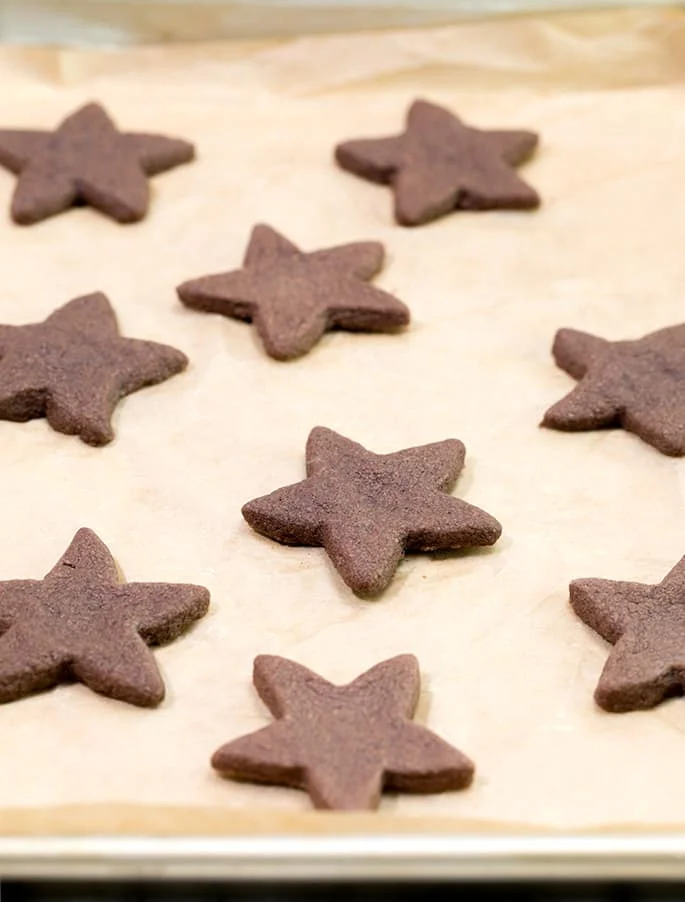Chocolate shortbread cookies on beige sheet