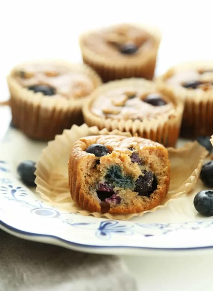Close up of a blueberry muffin on white plate