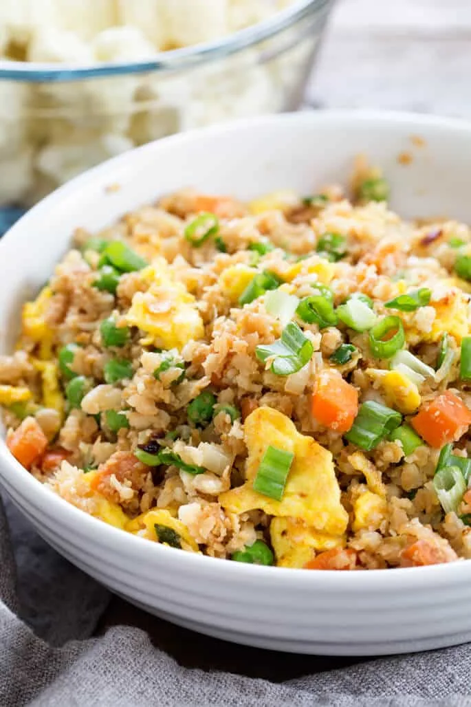 Close up of cauliflower fried rice in a white dish